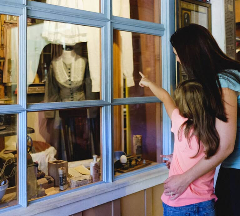 Mom and daughter are amazed by the historic display at Mariposa Museum and History Center