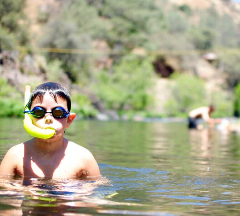 Boy swimming on the Merced River