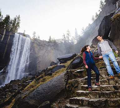 couple hiking down the mist trail by vernal fall