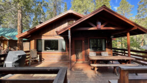 front exterior of cabin, deck with seating and grill