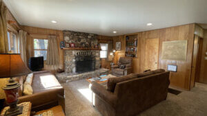 living room with large rock fireplace