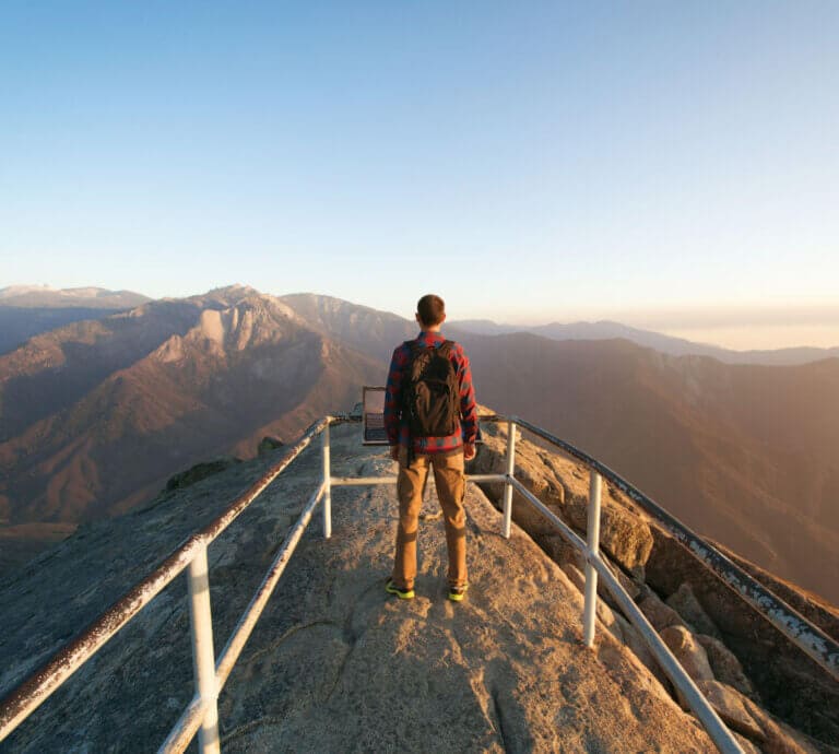 Person looking out from the summit of Moro Rock in Sequoia National Park