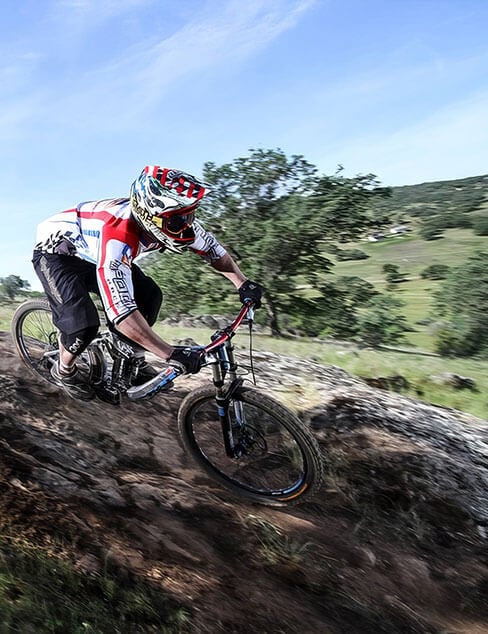 mountain biker on a steep descent at Exchequer Mountain Bike Park