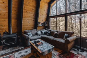 living room with couch and wood stove