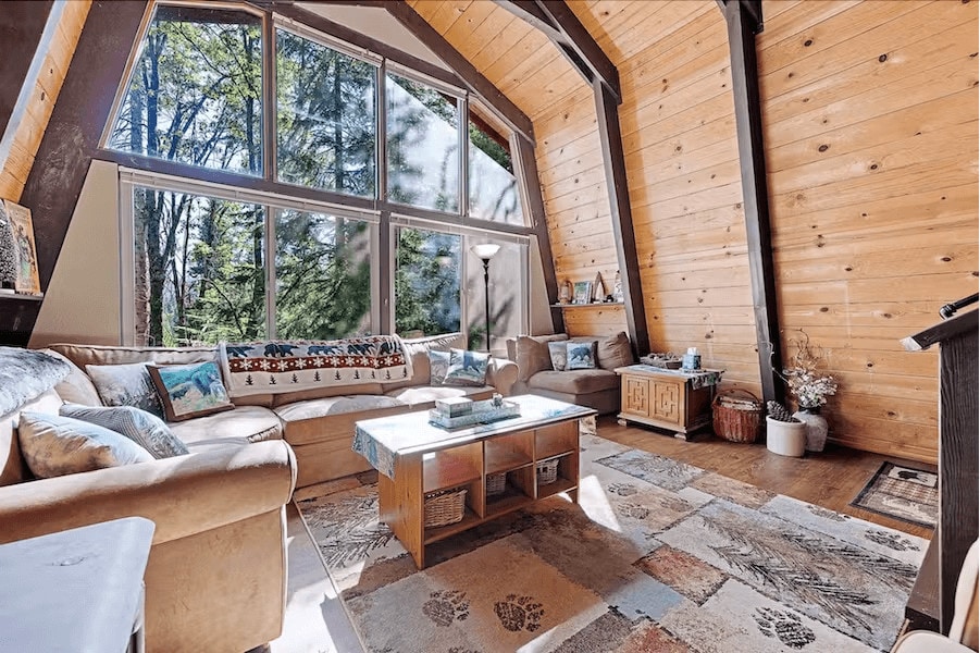 living room view of vaulted ceilings and wall of windows