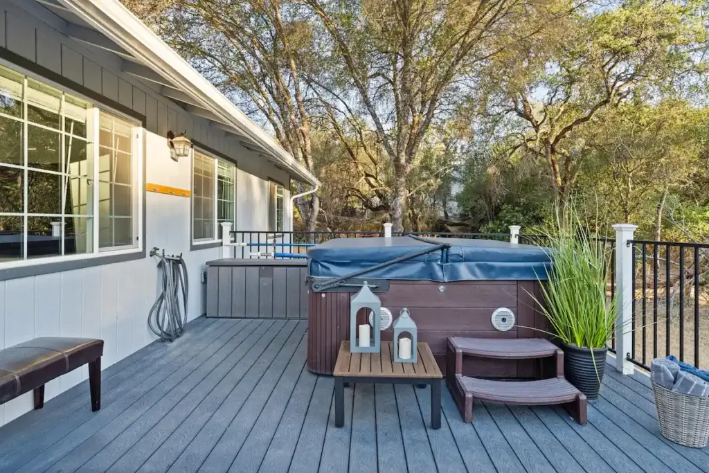 deck with hot tub and lanterns