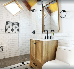 bathroom with star tile inlay, modern shower, vanity and toilet