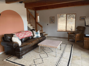 living room with couches, and wall arch painted detail