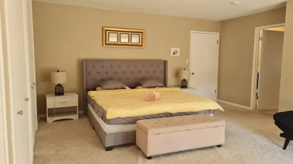 bedroom with king bed and ottoman storage