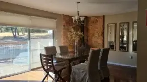 dining room with table and chairs and wood stove