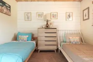 bedroom with two twin beds and dresser