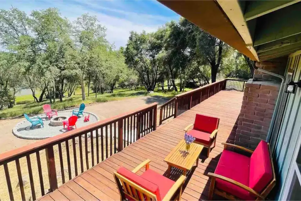 deck with outdoor seating and view of fire pit