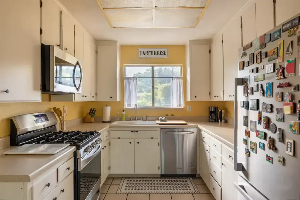 kitchen with fridge covered in magnets