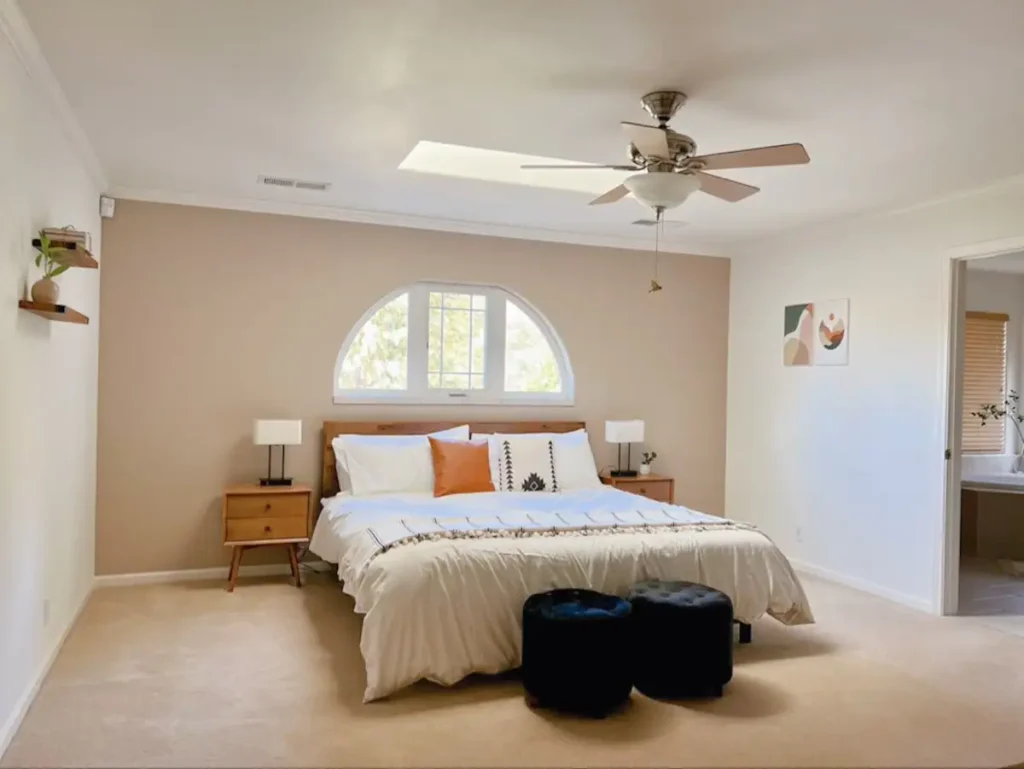 large bedroom with arched window