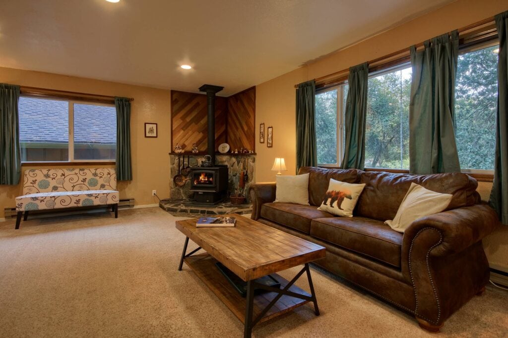 living room with wood stove and couches