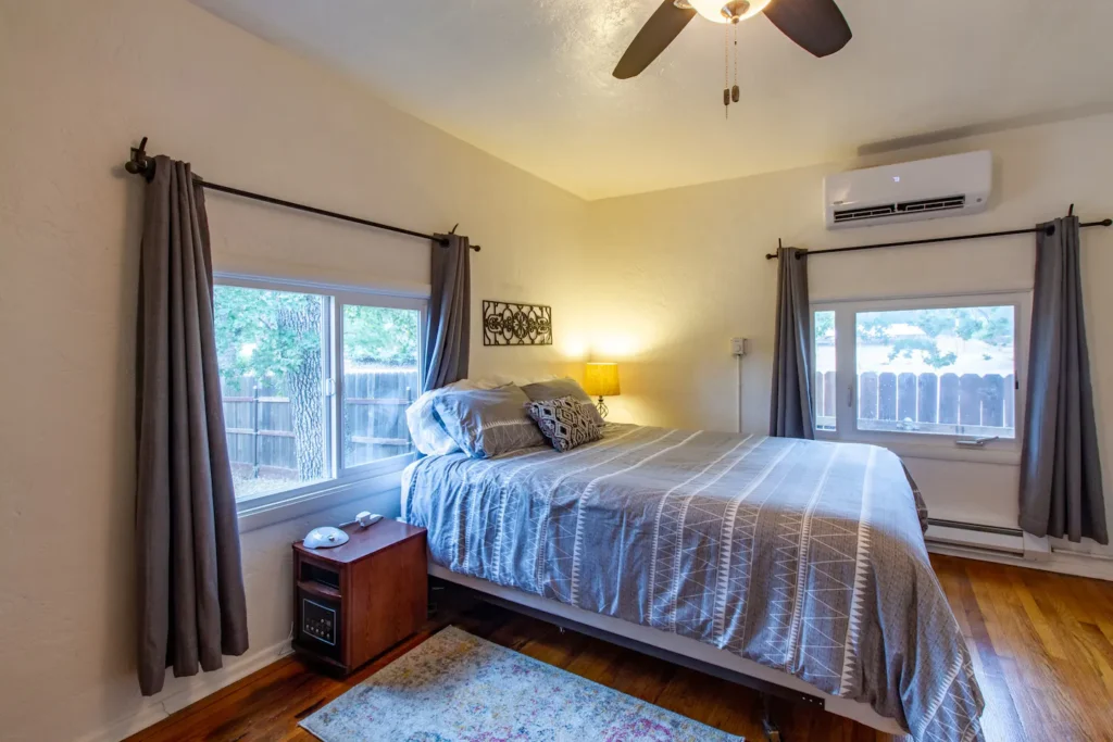 bedroom with queen bed and windows