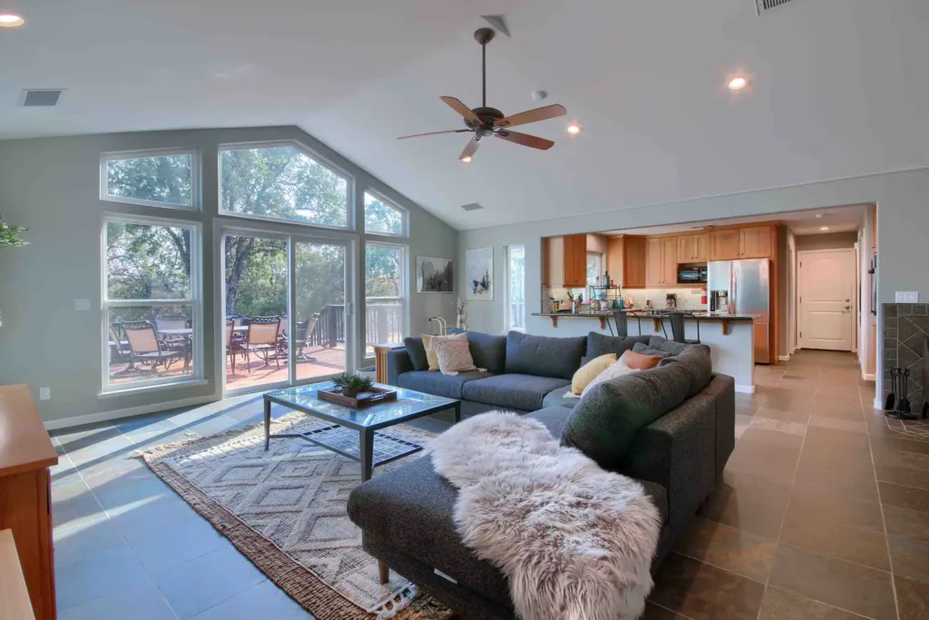 living room with tall ceilings and wall of windows with couch