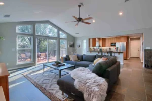 living room with tall ceilings and wall of windows with couch