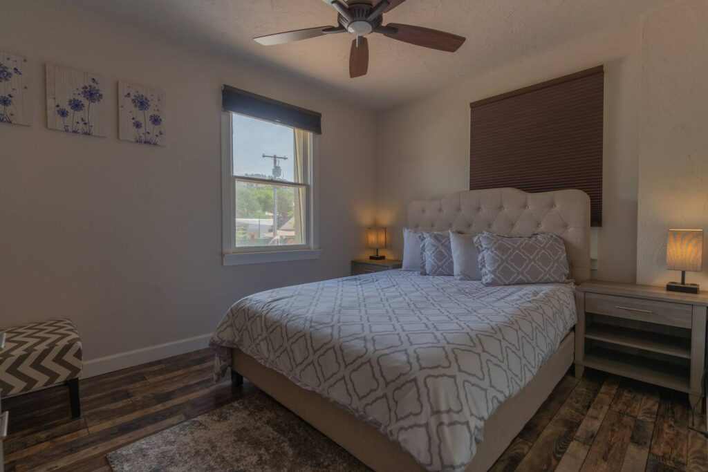 bedroom with queen size bed and window