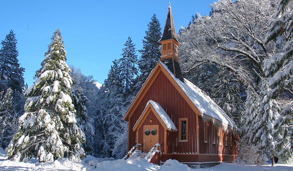Yosemite's chapel in winter covered in snow