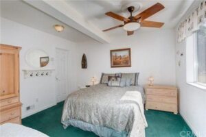 bedroom with queen bed and green carpet