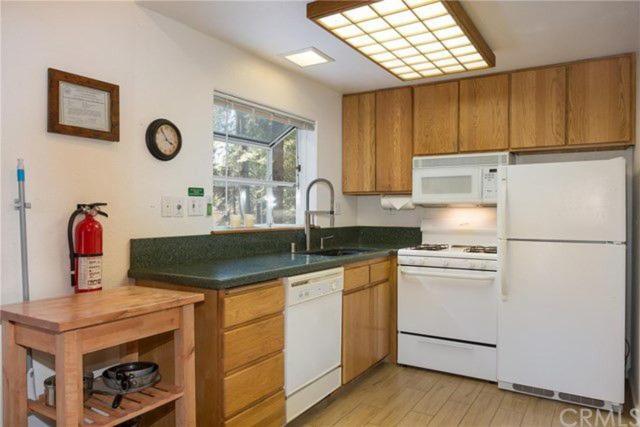 kitchen with green countertops and white appliances