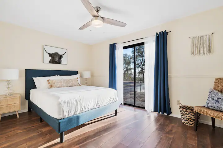 bedroom with queen bed and doors to patio