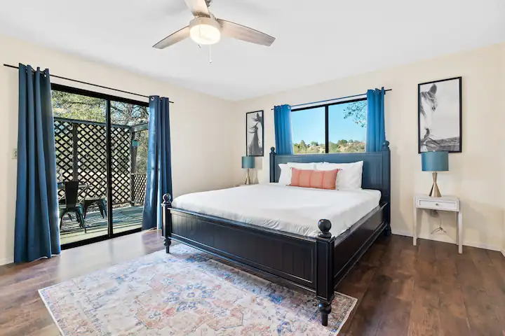 bedroom with queen bed and doors to patio