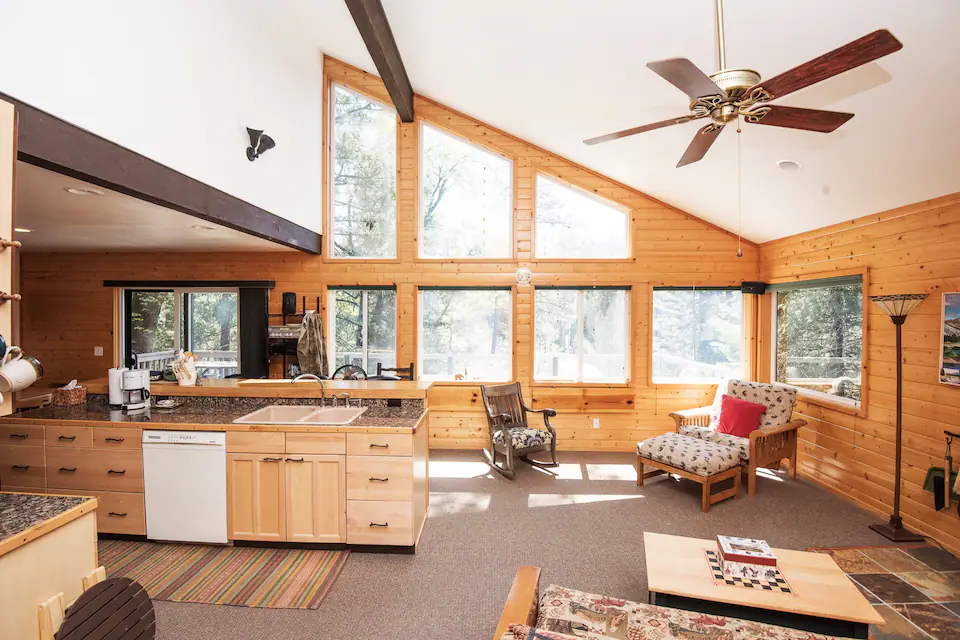 view of dining and kitchen from living room with vaulted ceilings