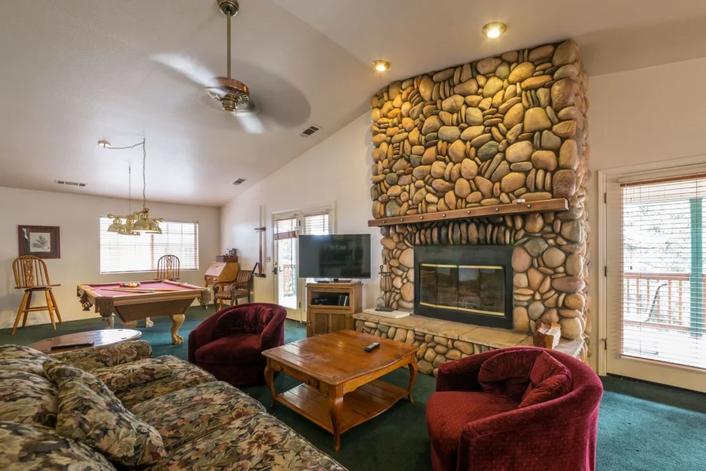 living room with stone fireplace and seating