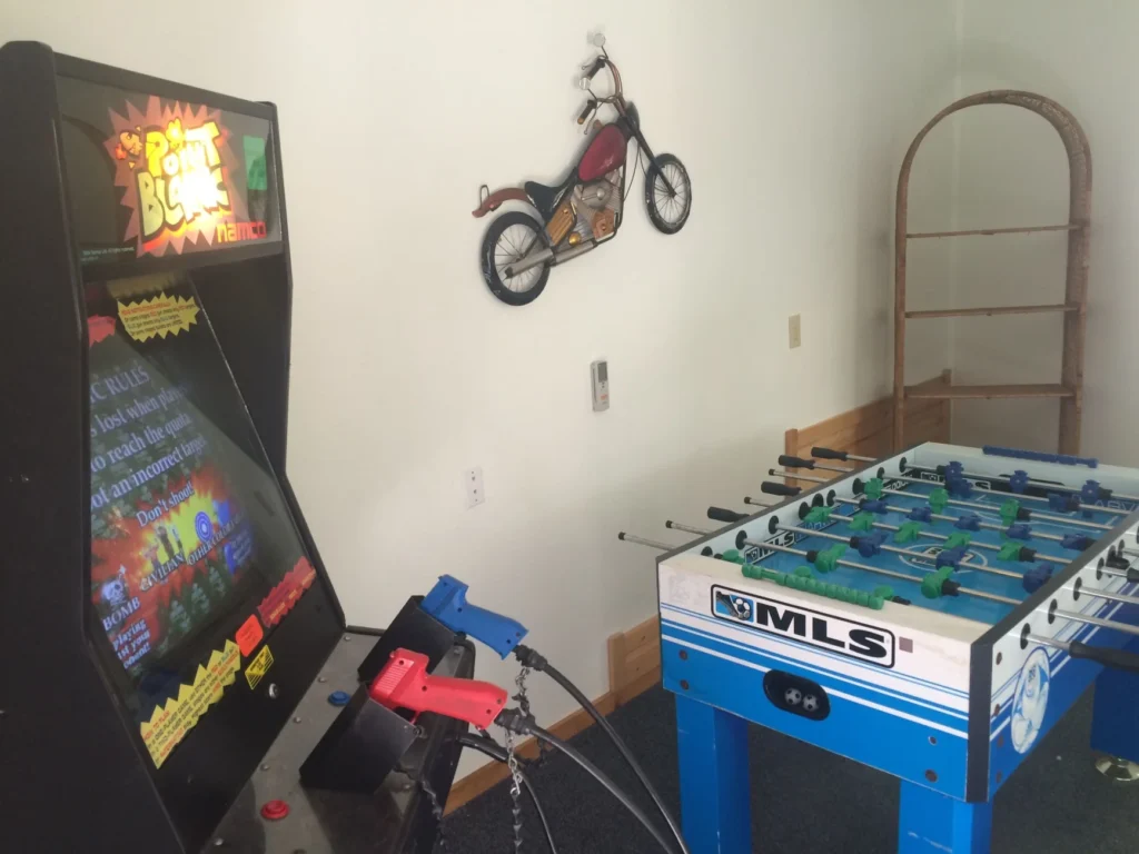 game room with arcade game and foosball table