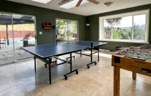 game room with ping pong table and foosball