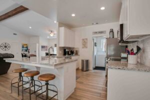 kitchen with white cabinets and bar seating