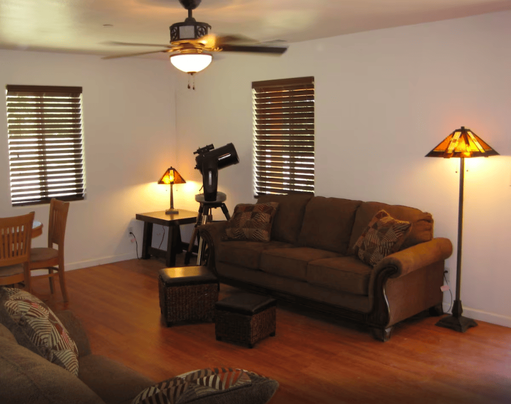 living room with couches and telescope