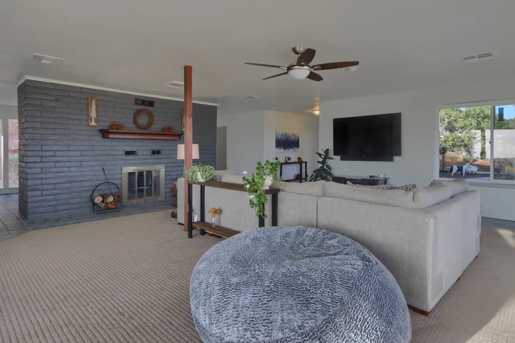 living room with fireplace television, and sectional couch