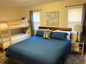 bedroom with queen bed and bunk beds