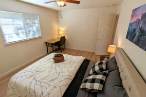 bedroom with queen bed and desk