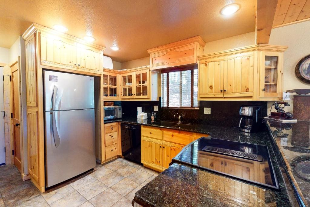 kitchen with wood cabinets and black countertops