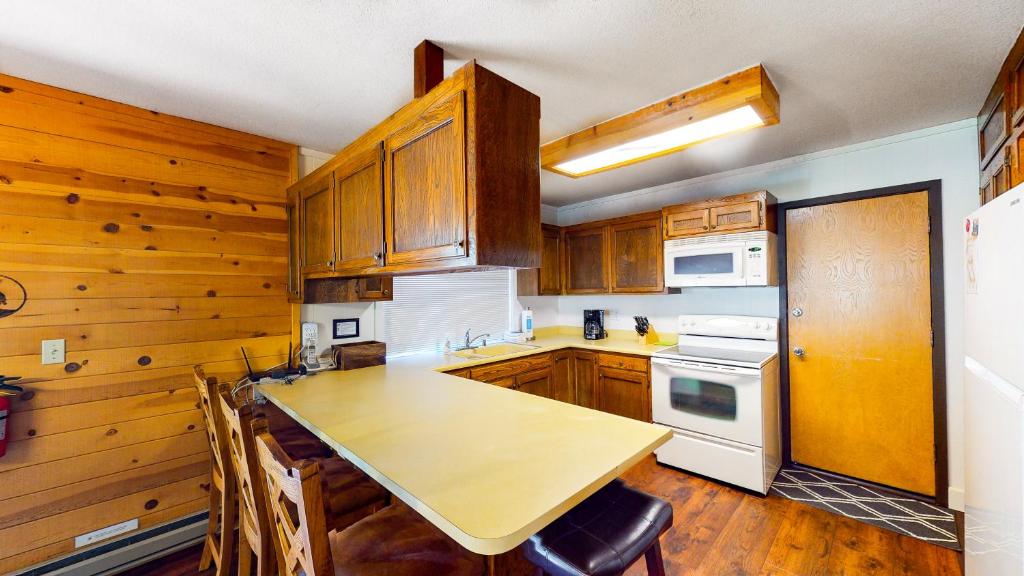 kitchen with peninsula island with seating and wood cabinets