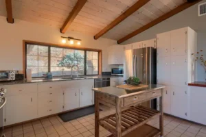 white kitchen with beams and island