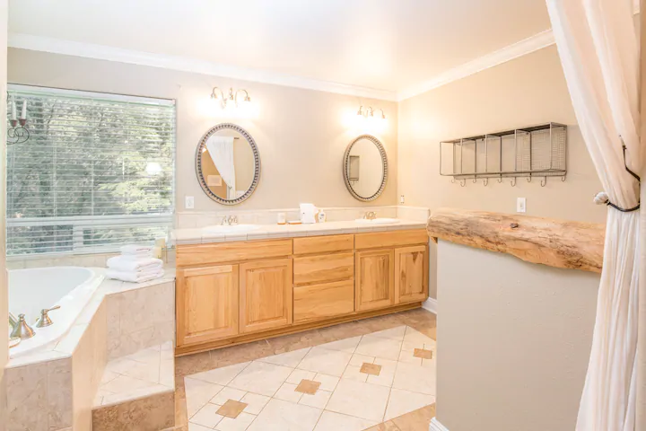 bathroom with spa tub and vanity