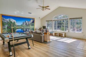 living room with large mural, pool table and seating