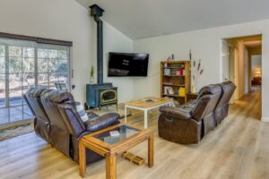 seating area with television and wood stove