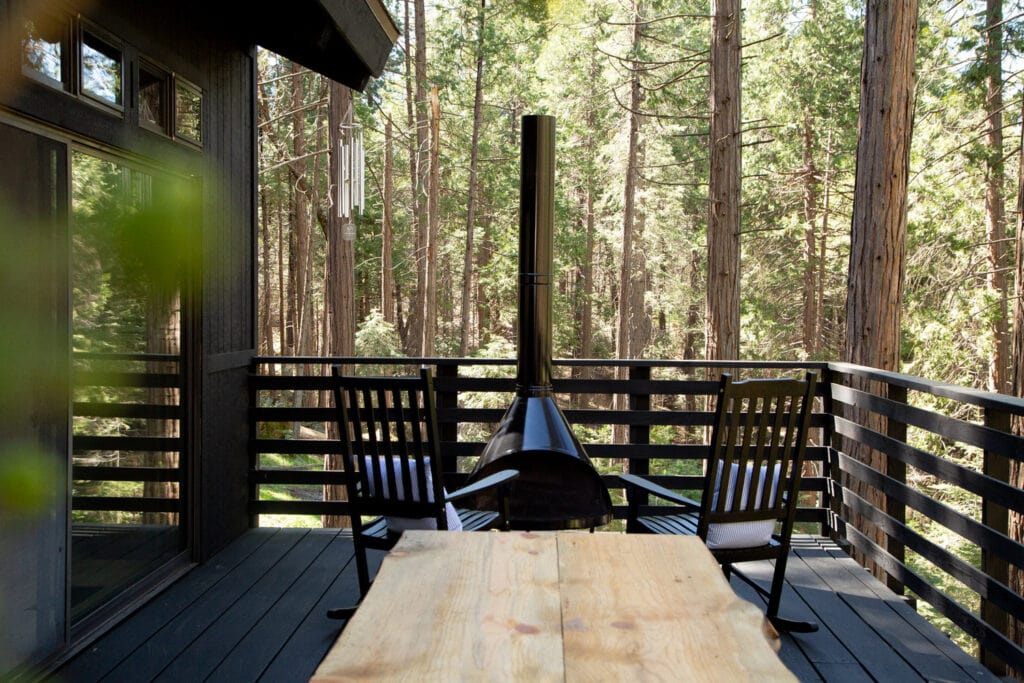 deck with outdoor fireplace and seating