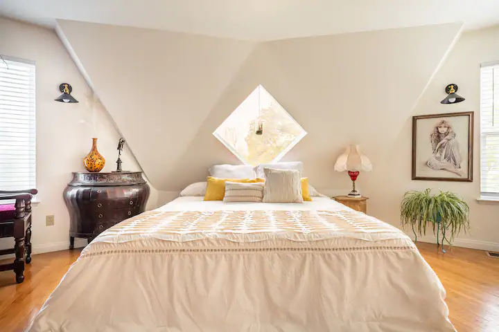 bedroom with diamond window and queen bed
