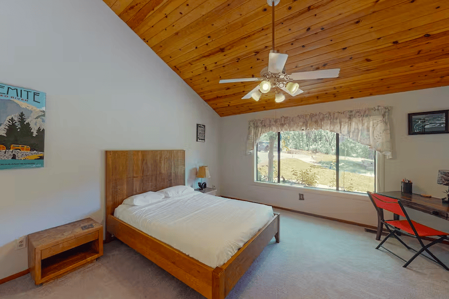bedroom with tall ceilings and queen bed