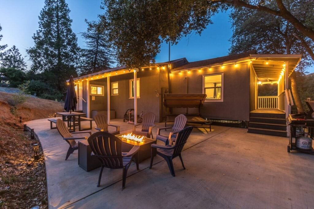 patio at night with fire pit and outdoor seating