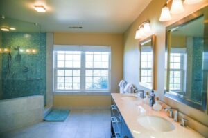 bathroom with walk in shower with blue accents