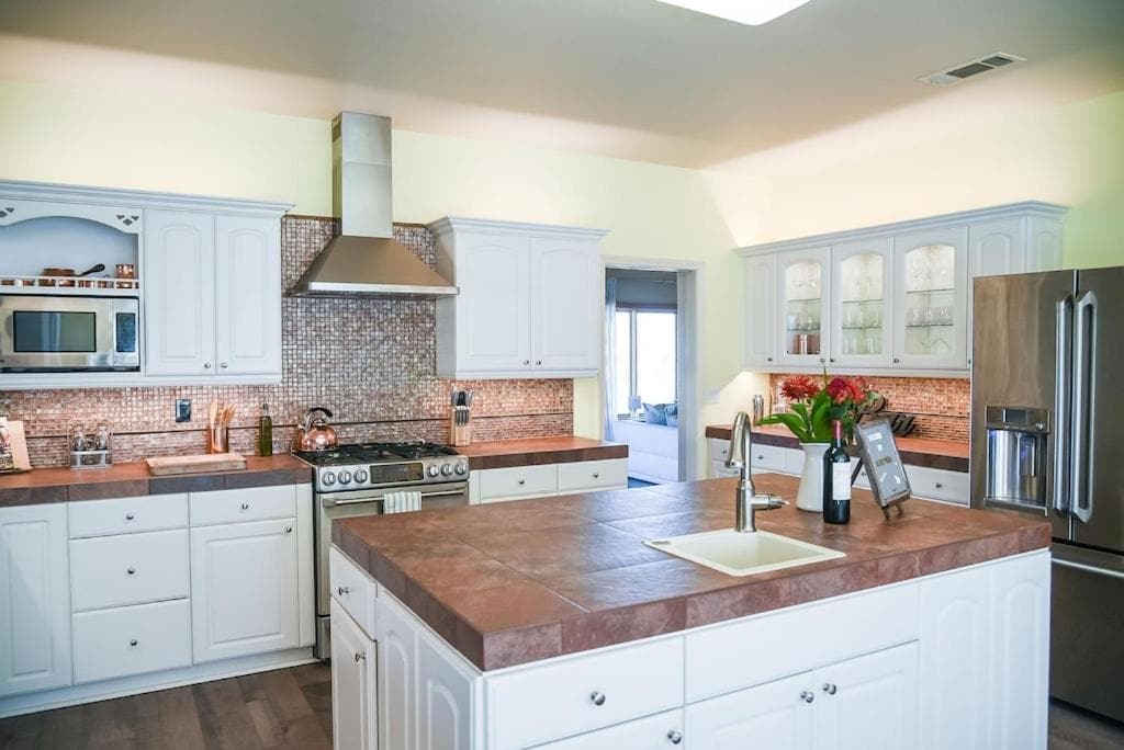 kitchen with white cabinets and island