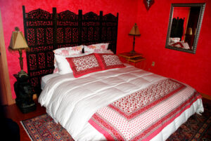 "manzanita room" with red walls and queen bed